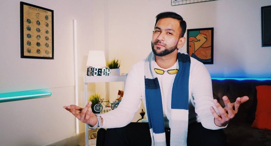 Asif speaking to camera in a studio