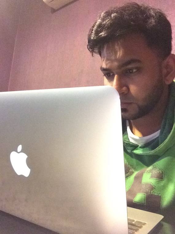 Asif editing on a laptop