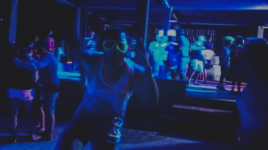 Asif dancing under blue lights